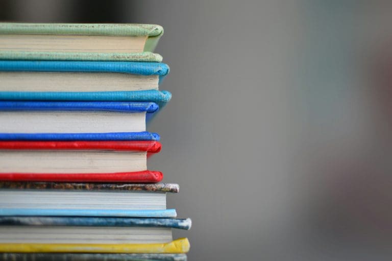 a colourful vertical stack of seven books