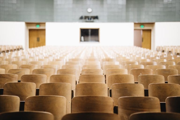 a large, empty auditorium with lots of wooden chairs