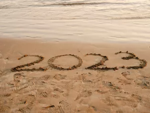 The year 2023 written in the sand