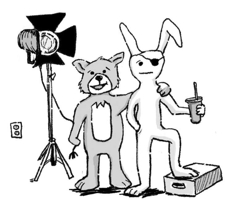a rabbit wearing an eyepatch and a fox embracing on a film set