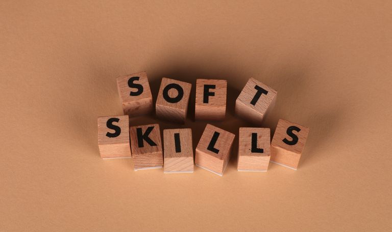 Wooden letter blocks spell out 'Soft Skills', highlighting business and personal development concepts.